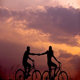We need other Christians, a couple ridiing a bike in the sunset.